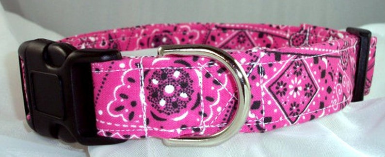May include: Pink and black bandana print dog collar with a silver buckle.