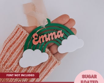 Könnte beinhalten: Grüner Regenbogen mit rosa Beschriftung "Emma" und zwei weißen Wolken. Dies ist eine laserfertige SVG-Datei.