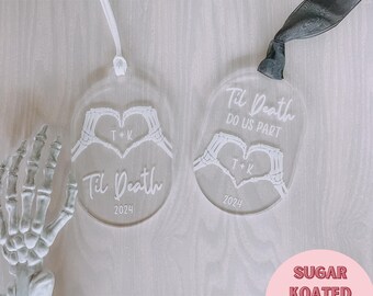 May include: Two clear acrylic ornaments with a skeleton hand design. The ornaments are engraved with the text "Til Death" and "Til Death Do Us Part". The ornaments are laser ready SVG files.