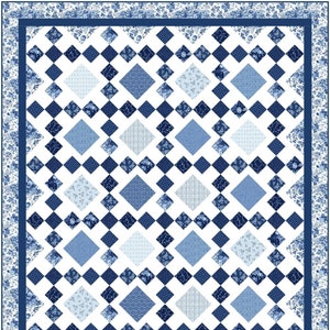 May include: A quilt with a white background and a pattern of blue diamonds. The diamonds are made up of different blue fabrics with floral and geometric designs. The quilt is bordered with a blue floral fabric.