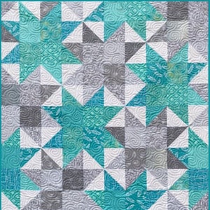 May include: A quilt with a geometric pattern of teal, gray, and white stars. The quilt is made with a variety of fabrics, including some with a swirl pattern. The quilt is labeled "Busy Hands Quilts".