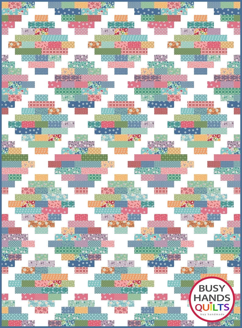 May include: A colorful quilt with a geometric pattern of squares and rectangles. The quilt is made with a variety of fabrics in shades of blue, green, pink, and orange. The quilt is bordered with a blue fabric. The quilt is labeled "Busy Hands Quilts" in a circle with a rainbow border.
