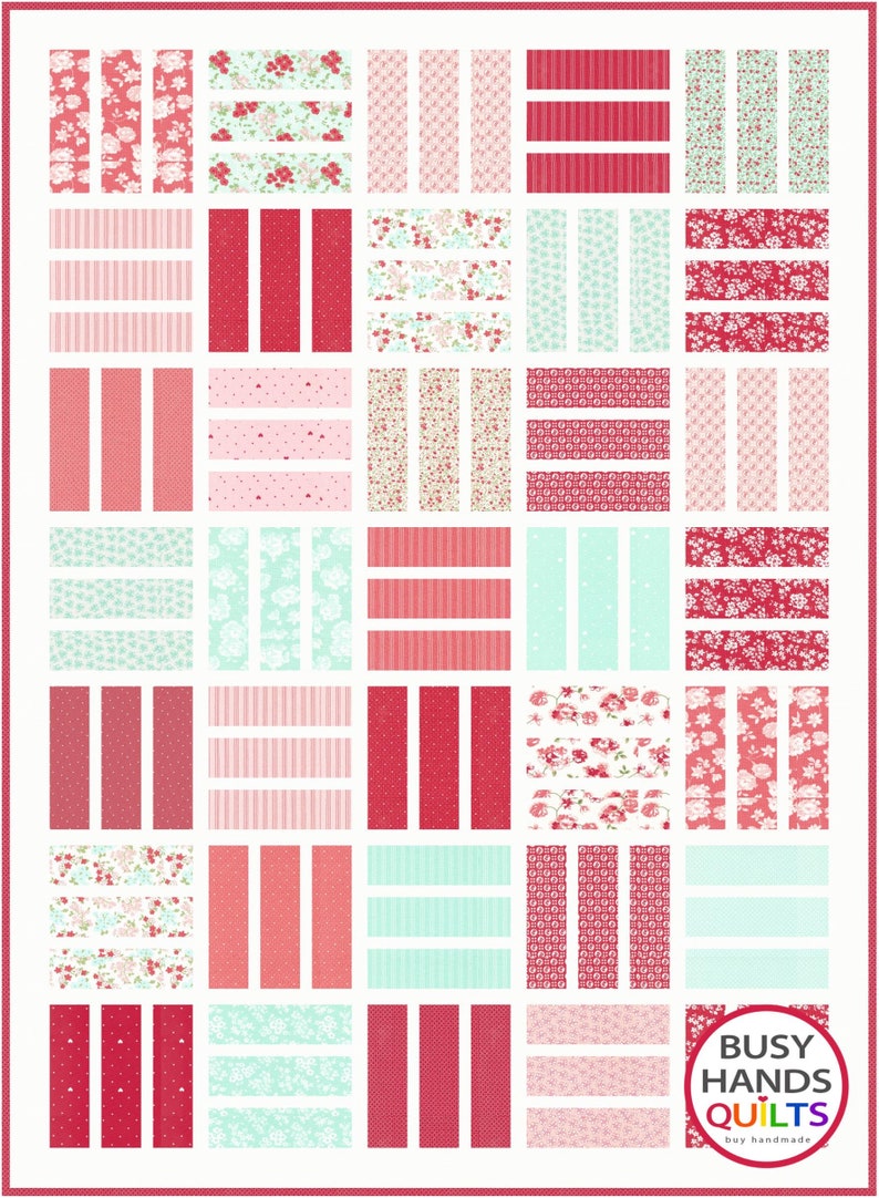 May include: A quilt pattern with a variety of red, pink, and blue fabrics. The pattern includes stripes, polka dots, and floral prints. The quilt is labeled "Busy Hands Quilts" with the tagline "buy handmade".