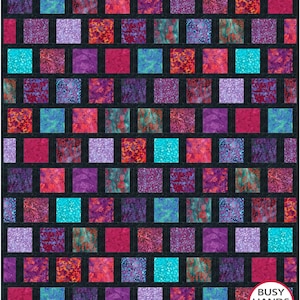 May include: A colorful quilt with a brick-like pattern. The quilt features squares in shades of teal, purple, pink, and orange, separated by black borders. The quilt is made by Busy Hands Quilts.