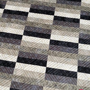 May include: A quilt with a checkered pattern in shades of gray and white. The quilt is quilted with a diamond pattern. The quilt is made by Busy Hands Quilts.