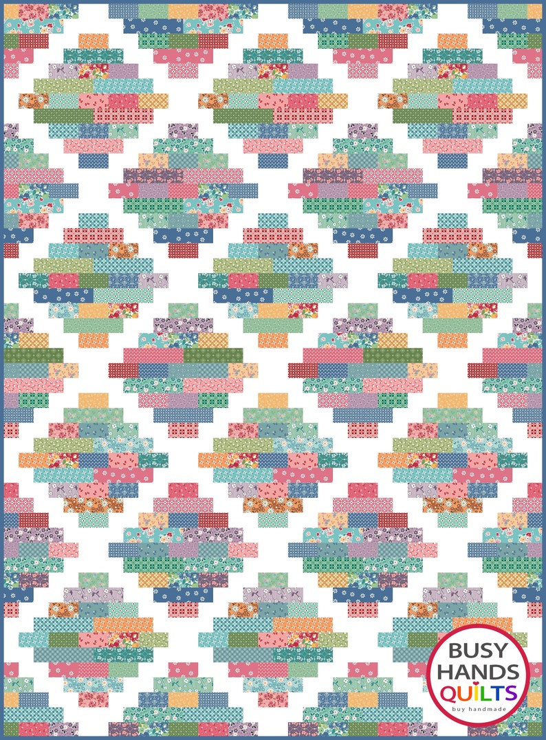 May include: A white quilt with a repeating pattern of colorful squares arranged in a diamond shape. The quilt is bordered in blue. The text "BUSY HANDS QUILTS buy handmade" is in a circle at the bottom right corner of the quilt.