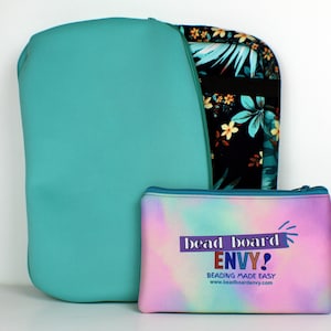 May include: Two teal blue zippered pouches, one larger than the other. The larger pouch has a tropical print on one side and solid teal on the other. The smaller pouch has a rainbow ombre design with the text "bead board ENVY! BEADING MADE EASY www.beadboardenvy.com".