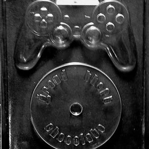 May include: A black plastic mould for making chocolate video game controllers and game discs. The mould has a design of a video game controller and a disc that says "Grand Theft Chocolate".