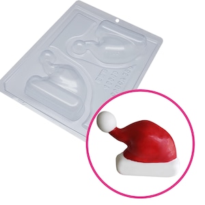 May include: A clear plastic mould for making chocolate Santa hats. The mould has two cavities, each shaped like a Santa hat with a white pom-pom on top. The mould is labelled "DWD 10049 6.4862A 3551".