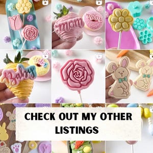 May include: A collection of colorful, decorated cookies and cake pops. The cookies are shaped like bunnies, flowers, and strawberries. The cake pops are decorated with flowers, roses, and the words "Mom" and "Baby".