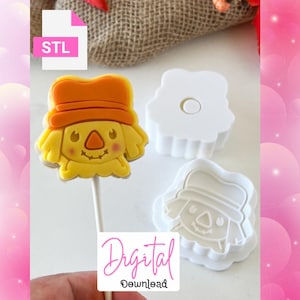 May include: A yellow and orange scarecrow-shaped cookie on a stick, with a matching cookie cutter and stamp. The image includes the text "STL" and "Digital Download".