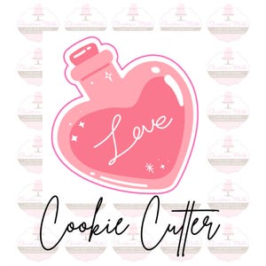 May include: Pink heart-shaped cookie cutter with a bottle inside and the word "Love" written in cursive.