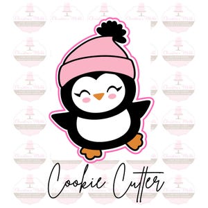 Könnte beinhalten: Ein rosa und schwarzer Ausstecher in Form eines Pinguins, der einen rosa Hut mit einem schwarzen Bommel trägt. Der Pinguin lächelt und hat einen kleinen orangefarbenen Schnabel. Der Ausstecher ist mit "Cookie Cutter" beschriftet.