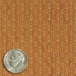 May include: Close-up of a textured fabric with a repeating pattern of vertical columns in shades of orange and gold. A silver dime is placed on the fabric for scale. The fabric has a woven appearance, suitable for upholstery or decorative use.