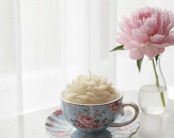 Handmade Rose Candle in a Soft Blue Ceramic Teacup, Decorated with Floral Patterns.