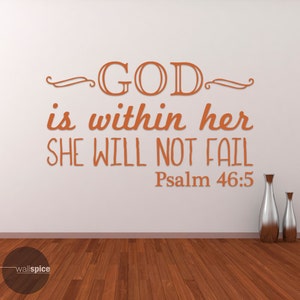 May include: A wall decal with the text "GOD is within her SHE WILL NOT FAIL Psalm 46:5" in orange lettering on a white wall. Two silver vases are on the floor in front of the wall.