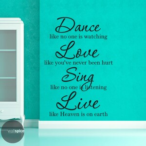 May include: A teal wall with black text that reads "Dance like no one is watching, Love like you've never been hurt, Sing like no one is listening, Live like Heaven is on earth." A white cabinet is on the left.