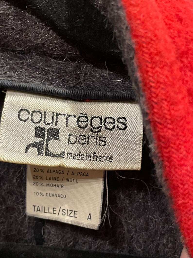 May include: A white tag with black text that reads "courr&egrave;ges paris made in frence" and lists the fabric composition: 20% Alpaca, 20% Wool, 20% Mohair, 10% Guanaco. The tag also says "Taille/Size A".