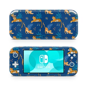May include: A blue and white Nintendo Switch Lite console with a custom skin featuring a repeating pattern of orange tigers on a blue background with green leaves. The console has a blue and white controller and the Nintendo Switch logo is visible on the screen.