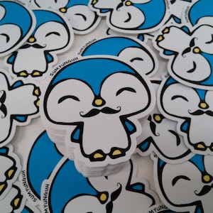 May include: A stack of blue and white penguin stickers with a mustache and a happy expression. The stickers have the text "SUMYUNGUH" on them.