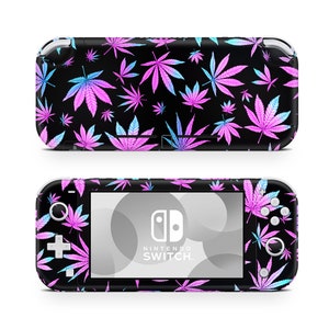 May include: A black Nintendo Switch Lite console with a pink and blue marijuana leaf pattern. The console has a white Nintendo Switch logo and the text "NINTENDO SWITCH" on the screen.