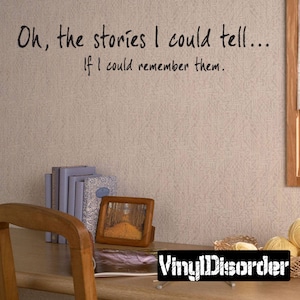 May include: A wall decal with the text "Oh, the stories I could tell... If I could remember them." The decal is on a light brown wall with a wooden desk and chair in the foreground.
