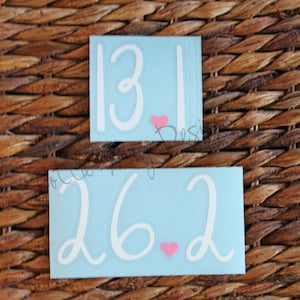 May include: Two blue vinyl stickers with white numbers and pink hearts. The top sticker says "13.1" and the bottom sticker says "26.2".