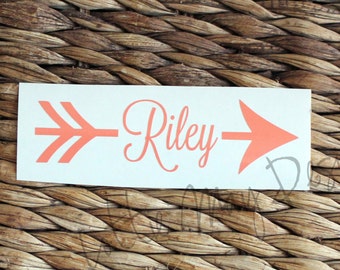 May include: A white sticker with an orange arrow and the name "Riley" in cursive.