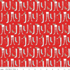 May include: Red fabric with a repeating pattern of white and red striped stockings with white cuffs and blue socks.  The background is a solid red color.  There are small green sprigs scattered throughout the fabric.