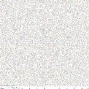 May include: A white background with a repeating pattern of small white flowers with blue centers. The flowers are arranged in a random pattern.