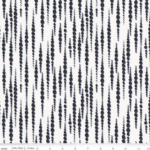 May include: White fabric with a repeating pattern of vertical lines of dark blue circles. The circles are of varying sizes and are arranged in a random pattern.