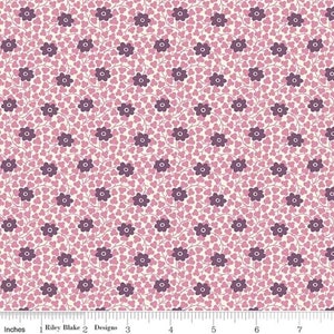 May include: Fabric with a floral pattern. The design features small, dark purple flowers and light purple clover-shaped leaves on a cream background. The flowers are connected by thin, brown stems. The fabric is marked with inches.