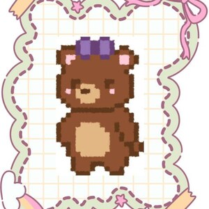 May include: A pixel art illustration of a brown bear with a tan belly and a purple bow on its head. The bear is centred within a scalloped, grid-patterned frame decorated with small stars, a pink ribbon bow at the top, and pastel-coloured tape accents.