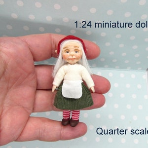May include: A miniature doll wearing a red hat, white sweater, green skirt, and red and white striped stockings. The doll is 1:24 scale, also known as quarter scale.