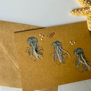 Tarjeta de medusas hecha a mano, tarjeta de notas con temática de medusas del océano, lápices de colores y marcadores usados, tarjeta de regalo para amantes de la playa adornada y caprichosa