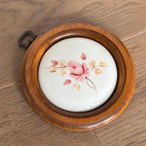 May include: A white ceramic mug with a black handle and the text "But First, Coffee" in a handwritten style. The mug is on a white surface. The mug is approximately 4 inches tall.