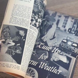 May include: An open vintage magazine with black and white photographs and text. The headline "Tune Up for Warm Weather" is visible. The pages are yellowed with age, suggesting a retro theme.