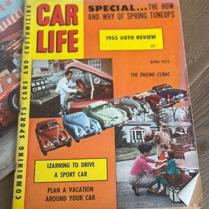 May include: Vintage April 1955 issue of Car Life magazine. The cover is orange with the title "CAR LIFE" in large red and yellow letters. Features include "1955 Auto Review" and "Learning to Drive a Sport Car."