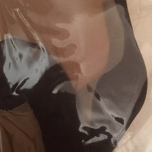 May include: A pair of sheer nude tights with a black waistband, packaged in a clear plastic bag.