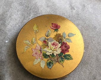 Original vintage gold effect circular English Crown powder compact decorated with painted rose bouquet, internal mirror, lid and sifter.