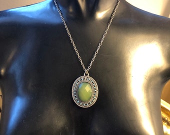 Antique silver effect long chain with filigree pendant dotted with aqua coloured stones and a faceted green stone