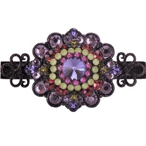 May include: A black metal hair clip with a large, ornate, purple, red, and green crystal design.