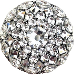 Könnte beinhalten: Eine runde, silberfarbene Brosche, dicht besetzt mit klaren, funkelnden Kristallen. Die Brosche hat einen großen, zentralen Kristall, der von Kristallen verschiedener Formen und Größen umgeben ist, was ein schillerndes, auffälliges Design ergibt.