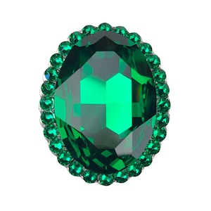 May include: A large, oval-shaped, emerald green gemstone with a faceted design. The gemstone is surrounded by a border of smaller, emerald green gemstones.