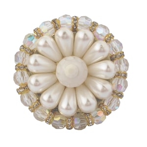 May include: A white pearl flower brooch with a center of white faux pearl surrounded by a ring of clear iridescent crystals.