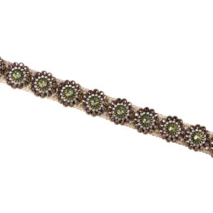 May include: A beaded trim with a row of pink and gold flower-shaped embellishments.