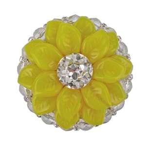 May include: A yellow flower-shaped button with a clear rhinestone centre. The button is surrounded by a silver-coloured trim.
