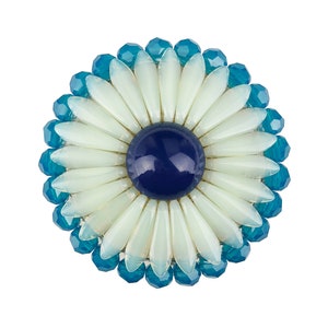May include: A white flower brooch with a blue centre, surrounded by blue beads.