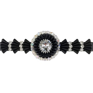 May include: Black hair clip with a large, clear rhinestone surrounded by smaller rhinestones and black beads.
