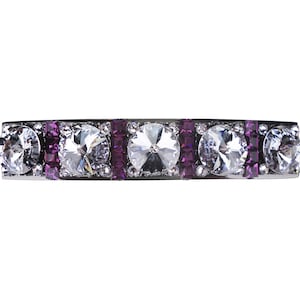 May include: A silver hair clip with five clear rhinestones and purple accents.